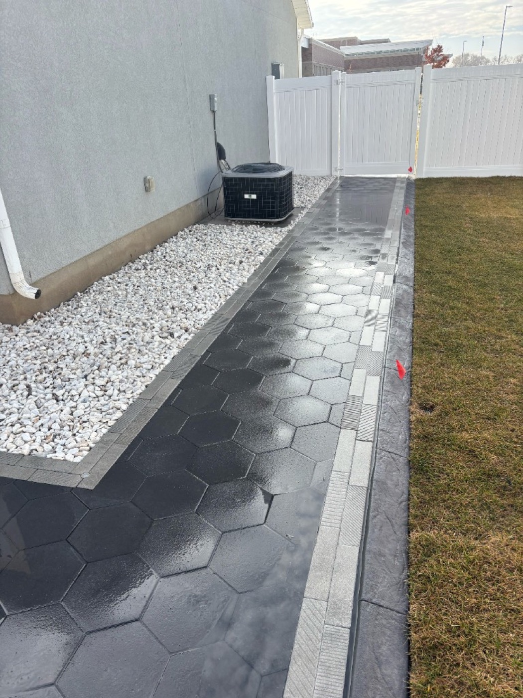 Dark hexagonal paver pathway with decorative border edging in Utah